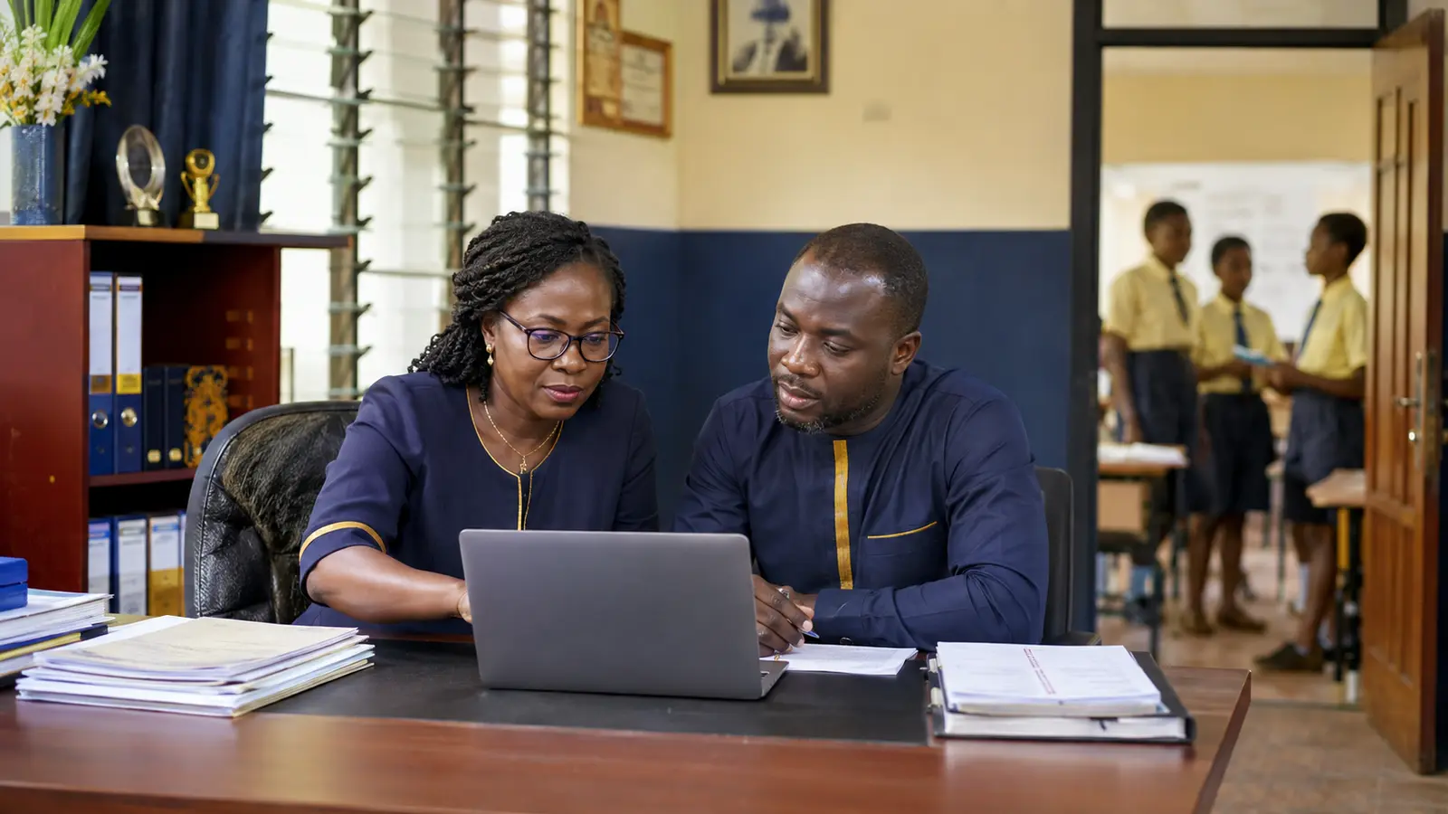Ghanaian private basic-school leaders reviewing institutional records together